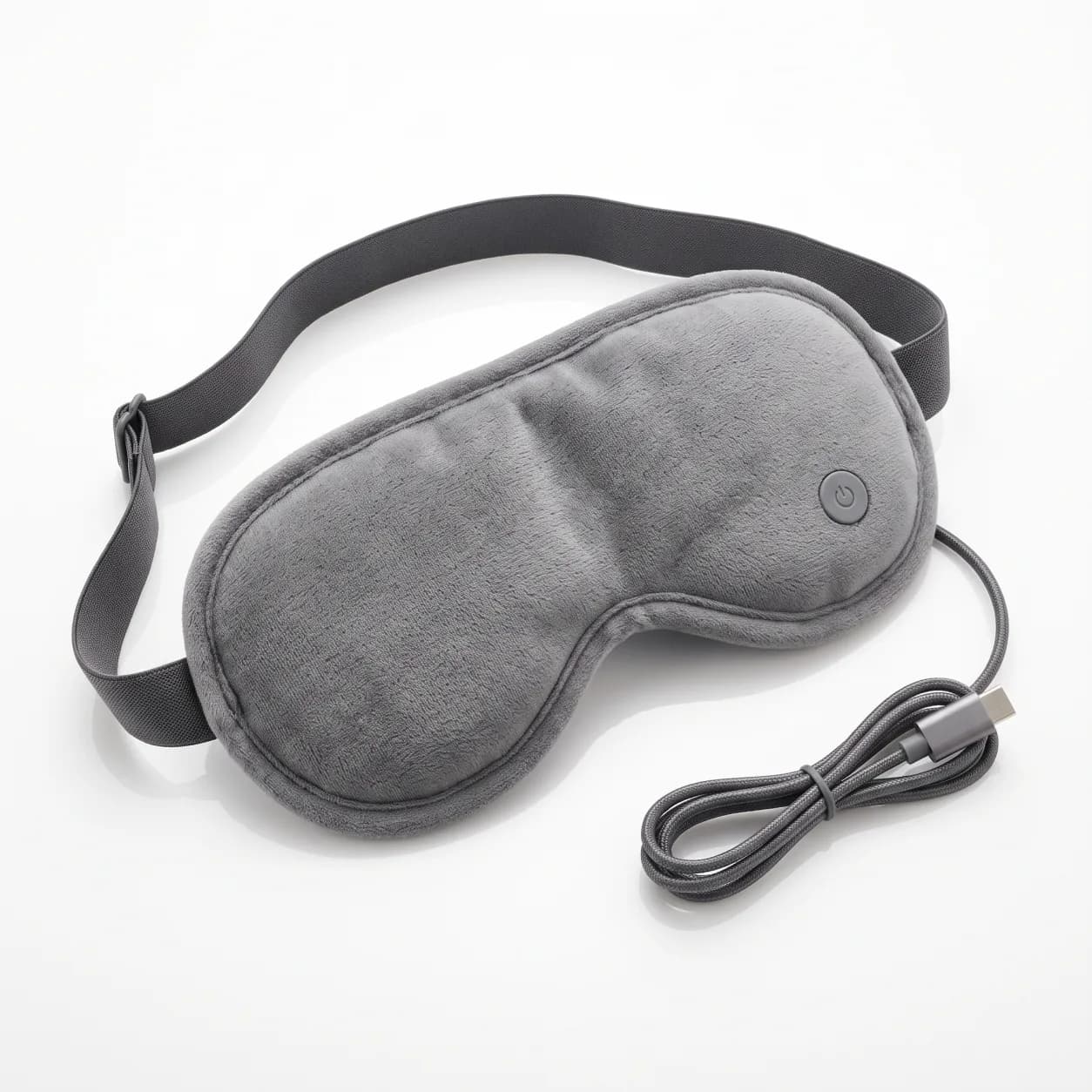 USB heated eye mask in grey, shown flat with its adjustable strap and USB-C charging cable